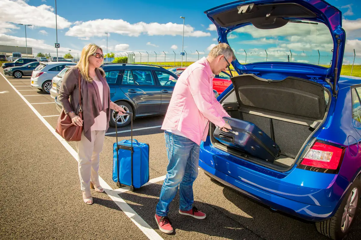 Person taking photos of a clean car before auto transport pickup.