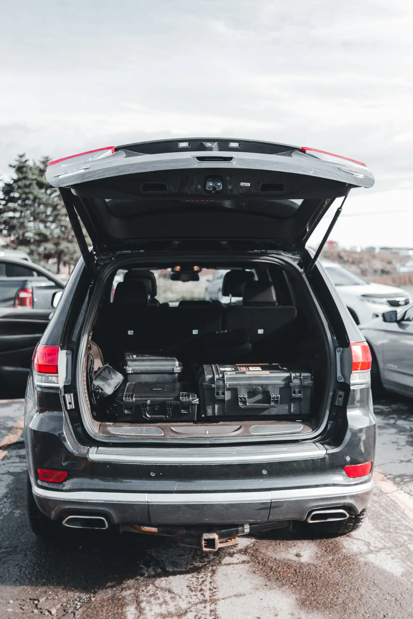 Car trunk filled with personal belongings packed below the window line for auto transport