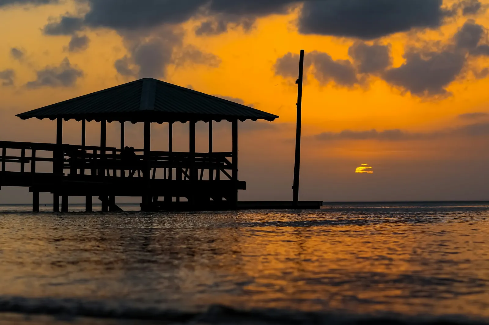 Sunset over Mobile Bay near Fairhope, Alabama, a popular snowbird car shipping destination